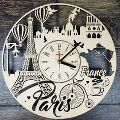 a clock with the words france written in different languages on it and an image of the eiffel tower