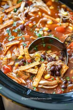 a crock pot filled with chicken tortilla soup