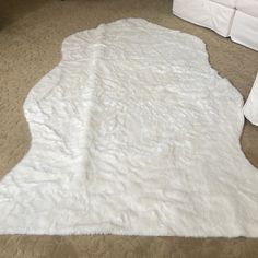 a white area rug on the floor in a living room