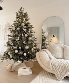 a living room with a christmas tree in the corner