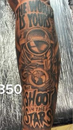 a man with a tattoo on his arm that says shoot the stars and is wearing an astronaut