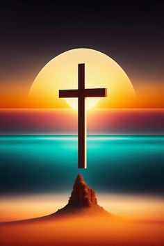 a cross on top of a hill in front of the ocean with a sunset behind it