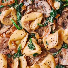 pasta with mushrooms and spinach in a skillet on a wooden table, ready to be eaten