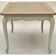 a small table with a wooden top and two drawers on one side, sitting against a white background