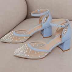 Elegant light blue wedding shoes featuring delicate pearl embroidery on mesh, a stylish block heel, and ankle strap. Perfect for adding a touch of sophistication to your bridal ensemble. Color: Lightblue Material: Vegan suede Heel Type: Block heel Heel Height: 2.16'' / 55 mm approx Product measurements were taken using size 8. Please note that measurements may vary by size. Toe: Pointy toe Pearl embroidery design Adjustable buckled ankle strap design Handcrafted US sizing. Fits true to size. Summer Wedding Tulle Heels, Blue Block Heel Wedding Shoes, Spring Wedding Heels With Tulle Material, Light Blue Ankle Strap Wedding Shoes, Blue Wedding Shoes For Prom In Spring, Light Blue Round Toe Wedding Shoes, Light Blue Heels For Spring Wedding, Short Heels For Wedding, Blue Shoes Bride