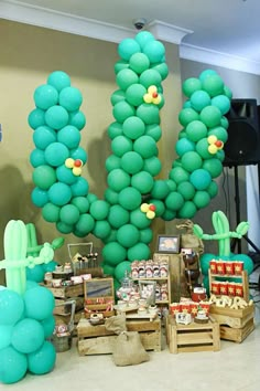 a table topped with lots of green balloons