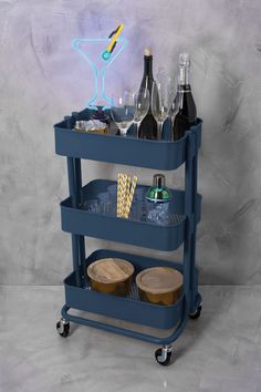 a blue cart with drinks and glasses on it