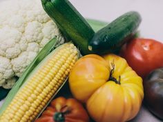 an assortment of fruits and vegetables sitting on top of each other