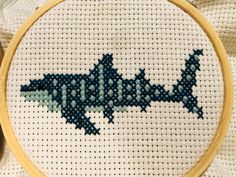 a cross stitch pattern with a shark on it