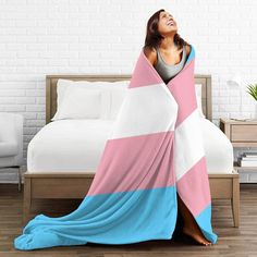 a woman wrapped in a pink and blue blanket