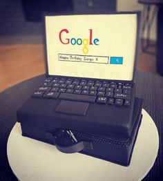 a laptop computer sitting on top of a white plate