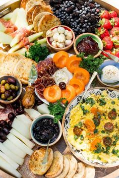 a platter filled with lots of different types of food and cheeses on it