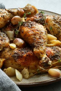 chicken with onions and herbs on a plate