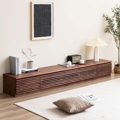 a living room with a white rug and wooden furniture