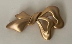 "Monet matte gold, satin gold bow, ribbon brooch  Vintage. Very good condition  All sizes approximately:  3\" x 1.75\"  marked: copyright Monet  Domestic shipping: USPS First class mail. 1-5 business days. I can file an insurance claim only after 20 business days after item was shipped International shipping: USPS First class mail. Approximately 7-21 business days. I can file an insurance claim only after 40 business days after item was shipped. I can not refund your money until claim is complet Elegant Gold Bow For Formal Occasions, Gold Satin Bow For Formal Occasions, Gold Bow Brooches For Formal Occasions, Elegant Gold Brooches With Ribbon, Formal Gold Brooch With Bow, Elegant Gold Bow As Gift, Elegant Gold Bow For Gifts, Gold Ribbon Bow For Party, Gold Party Bow With Ribbon