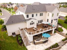 an aerial view of a house with a deck and patio area in the middle of it