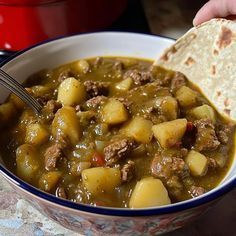 a bowl filled with stew and some tortilla