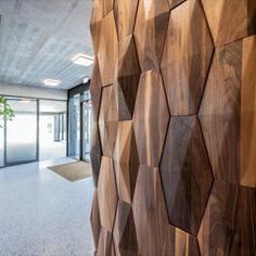 an office building with wood panels on the wall and planters in the doorways