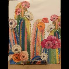 an image of a painting with flowers and cactuses on the back side of it