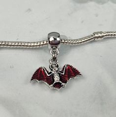 Red Enamel Vampire Bat Charm, Flying Bat Charm, Bat Dangle Charm, One Sided Charm, Spooky Halloween Charm, Dracula Fits Pandora plus all Designer and European charm bracelet, fits snake chain bracelets and necklaces. **Charm:  16 x23mm  Bail: 11x8mm Hole: 4.7mm   Zinc Alloy **Free USA domestic shipping after spending a specific amount (not including tax and shipping).  See shop announcement for free shipping info. **All orders are shipped immediately from Ohio.  If there is an exception to this, it will be posted in the shop announcement. Please be sure to review the photos of charm; if there are no measurements in above description please see measurement photos included. Reviewing the photos may prevent dissatisfaction due to size or other aspects of the charm upon receipt..  Charm and Be Flying Bat, Vampire Bat, Halloween Charms, Snake Chain Bracelets, Silver Plated Jewelry, Dangle Charms, Jewelry Cleaner, Pandora Bracelet, Dracula