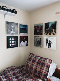 a bed sitting in a bedroom next to a wall with pictures on it