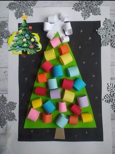 an origami christmas tree made out of colored cubes on a piece of paper