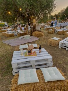 an outdoor event with hay bales and tables set up in the middle of it