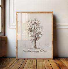 a framed photo with the words i am there among the trees on it in front of a window