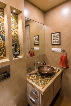 a bathroom sink sitting under a mirror next to a window