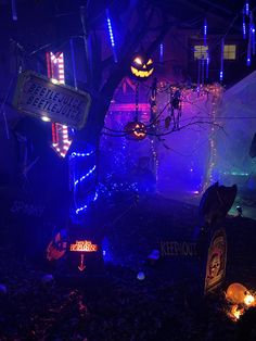 halloween decorations are lit up at night in an area that looks like it has been decorated for