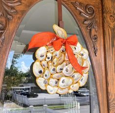 a wreath made out of oysters hanging on a door