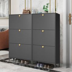 a gray cabinet with gold handles in a living room