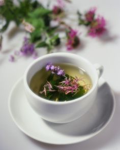 a cup of tea with some flowers in it