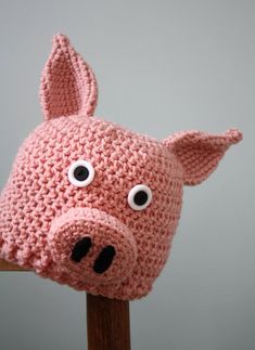 a crocheted pig hat with big eyes