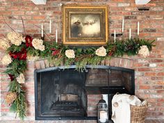 a fireplace decorated for christmas with flowers and greenery