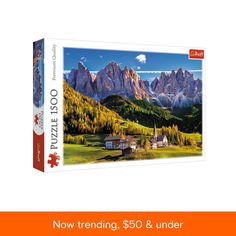 a jigsaw puzzle box with the image of a mountain village and mountains in the background