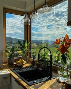 a kitchen with a large window overlooking the countryside