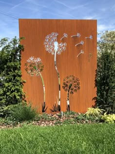 a large metal sculpture with dandelions on it