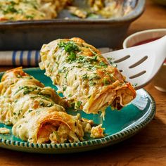 a green plate topped with lasagna covered in cheese