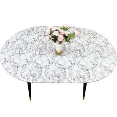 a white marble table with flowers on it