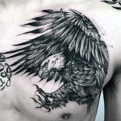 a man's chest with an eagle tattoo on it