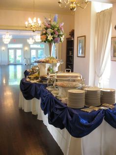 a buffet table is set up with plates and food