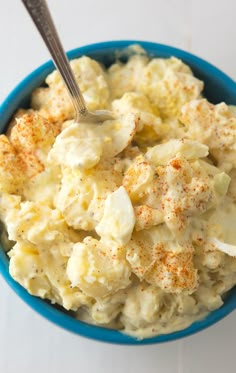 a blue bowl filled with macaroni and cheese