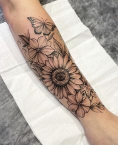 a woman's leg with flowers and butterflies on it