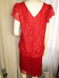 "A Holiday Red dress with short gathered sleeves, billowy lace bodice to the hips, fringe around the elastic hip area over the lace, round neckline, with an over the head try-on. Dress is rayon lined, and has a side split. Dress has no label, just a size 13/14 tag, and appears to have never been worn. Bust is about 40\", Shoulders 16 1/2\", Hips stretch to 40\", Unstretched Hips 32\". Dress in great condition. PRICE is $75.00Sale Final/As Is." Elegant Red Fringe Dresses, Elegant Red Dress With Fringe, Fitted Holiday Dresses With Fringe, Fitted Fringe Dress For Holidays, Vintage Fitted Dress With Fringe, Fitted Vintage Dresses With Fringe, Fitted Red Fringe Dress, Red Flapper Dress For Summer Evenings, Fitted Red Dress With Fringe