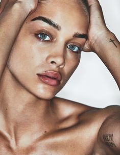 a close up of a person with tattoos on her arm and shoulder, posing for the camera