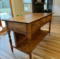 an old wooden table with two drawers on it