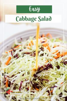 cabbage salad with carrots, celery and parmesan cheese being drizzled on top