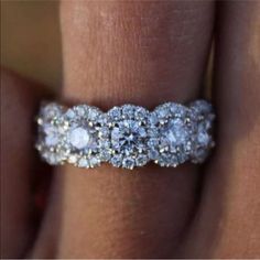 a woman's hand with a diamond ring on it