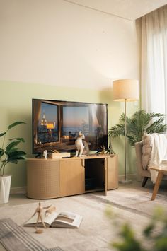 a cat sitting on top of a wooden entertainment center